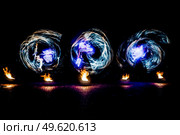 fiery pieces of a fire show against a dark sky and thunderstorms. Стоковое фото, агентство Ingram Publishing / Фотобанк Лори
