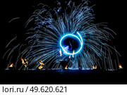fiery pieces of a fire show against a dark sky and thunderstorms. Стоковое фото, агентство Ingram Publishing / Фотобанк Лори