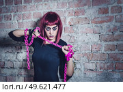 girl model in black with pink hair in an abandoned building. Стоковое фото, агентство Ingram Publishing / Фотобанк Лори