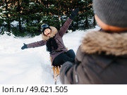 boy and girl outdoors on a winter walk playing snowballs and sledding. Стоковое фото, агентство Ingram Publishing / Фотобанк Лори