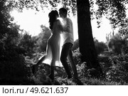 guy and a girl walk along the paths of a forest park between tall trees. Стоковое фото, агентство Ingram Publishing / Фотобанк Лори