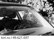 blonde with pigtails in a shirt, jeans, red shoes and black glasses near a white car. Стоковое фото, агентство Ingram Publishing / Фотобанк Лори