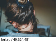 Back view of a comfortly bun hairstyle of a young woman. Стоковое фото, агентство Ingram Publishing / Фотобанк Лори