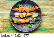 Appetizing pieces of dried salted salmon on wooden skewers. Dried fish salmon. Стоковое фото, агентство Ingram Publishing / Фотобанк Лори