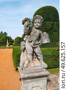 Classical Putto Sculpture in Buchlovice Palace Park (Czech Republic). Baroque garden statue with ASIA inscription, summer veiw. Стоковое фото, фотограф Елена  Попкова / Фотобанк Лори