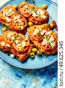 Thin layer of meat, breaded in breadcrumbs with cheese, olives and tomato. Meat dish - schnitzel. Meat schnitzel with cheese, olives and tomato. Стоковое фото, агентство Ingram Publishing / Фотобанк Лори