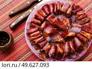 Sliced basturma or meat jerky.Beef jerky,dried beef on plate.Armenian food. Beef cured and spice,basturma. Стоковое фото, агентство Ingram Publishing / Фотобанк Лори