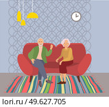 Elderly couple sitting on the sofa at home in livingroom interior. Retired elderly couple in love. Grandparents family, grandmother and grandfather happy friends sitting on the couch communicating. Elderly couple sitting on the sofa at home. Retired elderly couple in love. Grandparents family. Стоковая иллюстрация, агентство Ingram Publishing / Фотобанк Лори