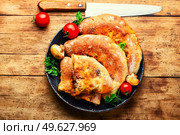 Closed pizza with mushrooms. Calzone - Italian pie. Calzone - Italian pie, pizza. Стоковое фото, агентство Ingram Publishing / Фотобанк Лори