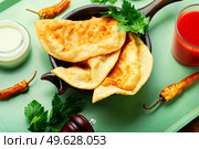Cheburek, a dish of unleavened dough stuffed with minced meat. Traditional homemade pasties, cheburek. Стоковое фото, агентство Ingram Publishing / Фотобанк Лори