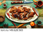Spicy vindaloo meat with rice. Pork cooked in spicy garlic sauce. Vindaloo, meat in fried spices. Стоковое фото, агентство Ingram Publishing / Фотобанк Лори