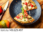 Pizza with salami, cheese, tomato on a pumpkin crust. Homemade autumn recipe. Pizza on pumpkin flatbread. Стоковое фото, агентство Ingram Publishing / Фотобанк Лори