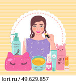 Beautiful girl makes look and does makeup, looks after beauty and paints lips on yellow background. Makeup cosmetics tools and Korean cosmetics. Beauty products collection for skin care and health. Beautiful girl makes look and does makeup looks after beauty and paints lips on yellow background. Стоковая иллюстрация, агентство Ingram Publishing / Фотобанк Лори