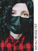 Young woman wearing a black face mask. Стоковое фото, агентство Ingram Publishing / Фотобанк Лори