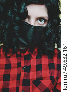 Young woman wearing a black face mask. Стоковое фото, агентство Ingram Publishing / Фотобанк Лори