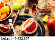 Delicious hookah with orange, lime, lemon and grapefruit. Relaxation citrus hookah tobacco.. Smoking hookah with citrus fruits. Стоковое фото, агентство Ingram Publishing / Фотобанк Лори
