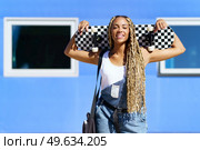 Young black girl smiling with coloured braids. Typical African hairstyle.. Black girl smiling with coloured braids. Typical African hairstyle. Стоковое фото, агентство Ingram Publishing / Фотобанк Лори
