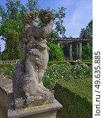 Classical Putto Sculpture in Buchlovice Palace Park (Czech Republic). Baroque garden statue with ASIA inscription, summer veiw. Стоковое фото, фотограф Елена  Попкова / Фотобанк Лори