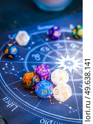 Horoscope zodiac circle with divination dice. Fortune telling and astrology predictions concept, magic rituals and exoteric experience. Zodiac horoscope with divination dice. Стоковое фото, агентство Ingram Publishing / Фотобанк Лори