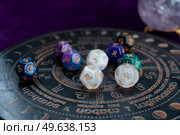 Horoscope zodiac circle with divination dice. Fortune telling and astrology predictions concept, magic rituals and exoteric experience. Zodiac horoscope with divination dice. Стоковое фото, агентство Ingram Publishing / Фотобанк Лори