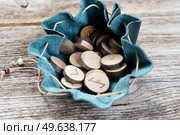 Handmade runes for fortunetelling in leather bag close up. Handmade runes for fortunetelling. Стоковое фото, агентство Ingram Publishing / Фотобанк Лори