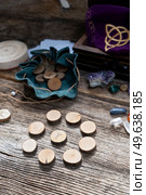 Handmade runes for fortunetelling in leather bag close up. Handmade runes for fortunetelling. Стоковое фото, агентство Ingram Publishing / Фотобанк Лори