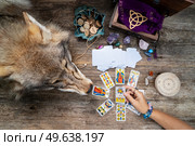Fortune telling on tarot cards, witch hand is opening cards, used Marseille Tarot deck by unknown artist published first in 1709. Fortune telling on tarot cards. Стоковое фото, агентство Ingram Publishing / Фотобанк Лори