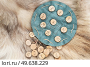 Handmade runes for fortunetelling over green leather chart. Handmade runes for fortunetelling. Стоковое фото, агентство Ingram Publishing / Фотобанк Лори