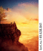 A young man and his faithful dog meet the sunset together as best friends. Beautiful painting with a person and a pup on the edge of the cliff watching the sundown over the valley. Wonderful nature. Стоковое фото, агентство Ingram Publishing / Фотобанк Лори