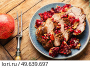 Appetizing piece of pork loin in a fruity marinade. Fried meat with pomegranate.. Pork loin in pomegranate marinade. Стоковое фото, агентство Ingram Publishing / Фотобанк Лори