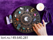 Top view of astrologer hands making forecast of fate. Astrological forecast, mysticismm and science concept. Astrological background.. Top view of astrologer hands. Стоковое фото, агентство Ingram Publishing / Фотобанк Лори