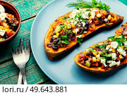 Batata stuffed with vegetables and cottage cheese and baked in halves. Diet food, baked vegetable, sweet potato. Sweet potato stuffed with vegetables and cottage cheese. Стоковое фото, агентство Ingram Publishing / Фотобанк Лори