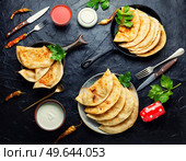 Chebureks making yeast dough, stuffing with minced beef. Traditional homemade pasties, cheburek. Стоковое фото, агентство Ingram Publishing / Фотобанк Лори
