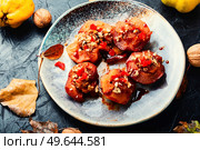 Dessert of caramelized quince with nuts and candied fruits. Eastern sweets. Sweet tasty quince dessert. Стоковое фото, агентство Ingram Publishing / Фотобанк Лори