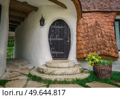The Clay Castle from the Valley of Fairies, a touristic complex in Transylvania, Romania. Closeup view to a tiny entrance door, fantasy hobbit house from tales. Стоковое фото, агентство Ingram Publishing / Фотобанк Лори