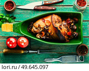 Delicious roast pork knuckle in the baking dish. Tasty roast pork hock. Стоковое фото, агентство Ingram Publishing / Фотобанк Лори