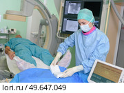 patient lying on mri machine while doctor operating it. Стоковое фото, агентство Ingram Publishing / Фотобанк Лори