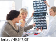 female medical workers looking at xrays while on break. Стоковое фото, агентство Ingram Publishing / Фотобанк Лори