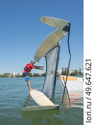 salior trying to right his catamaran after capsize. Стоковое фото, агентство Ingram Publishing / Фотобанк Лори