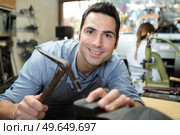 close up of a happy shoe repairman. Стоковое фото, агентство Ingram Publishing / Фотобанк Лори