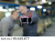 piece of metal metalworks factory - blurred background people. Стоковое фото, агентство Ingram Publishing / Фотобанк Лори