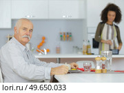senior man in wheelchair with help of daughter. Стоковое фото, агентство Ingram Publishing / Фотобанк Лори