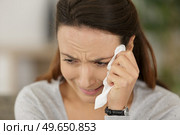 sad woman crying at home. Стоковое фото, агентство Ingram Publishing / Фотобанк Лори