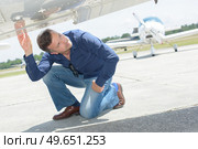 Man checking underside of aircraft. Стоковое фото, агентство Ingram Publishing / Фотобанк Лори