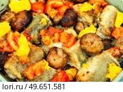 Roasted hake fish with orange, tomato and mushrooms. Food background. Baked dietary sea fish hake,macro. Стоковое фото, агентство Ingram Publishing / Фотобанк Лори