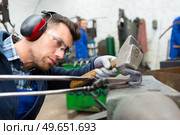blacksmiths work as forging forging on metal. Стоковое фото, агентство Ingram Publishing / Фотобанк Лори