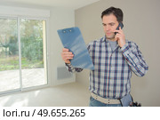 man on the phone is verifying the information. Стоковое фото, агентство Ingram Publishing / Фотобанк Лори
