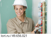portrait of female plumber by mains water pipes. Стоковое фото, агентство Ingram Publishing / Фотобанк Лори