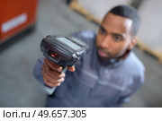 close up of worker scanning barcode. Стоковое фото, агентство Ingram Publishing / Фотобанк Лори