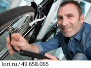 the man inflates bicycle wheel using a pump. Стоковое фото, агентство Ingram Publishing / Фотобанк Лори